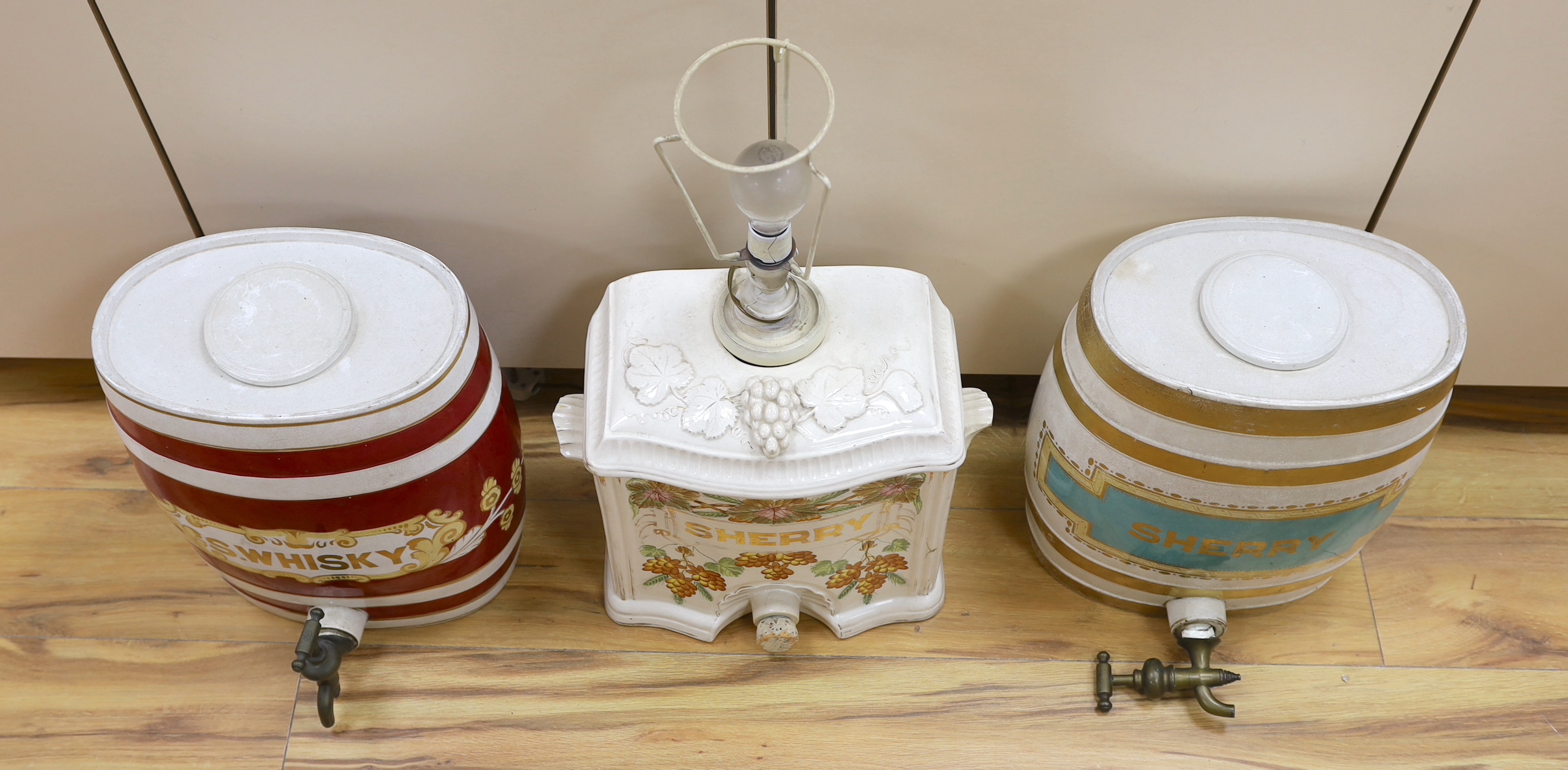 Two pottery sherry barrels (one mounted as a lamp) and flasks and a whisky barrel